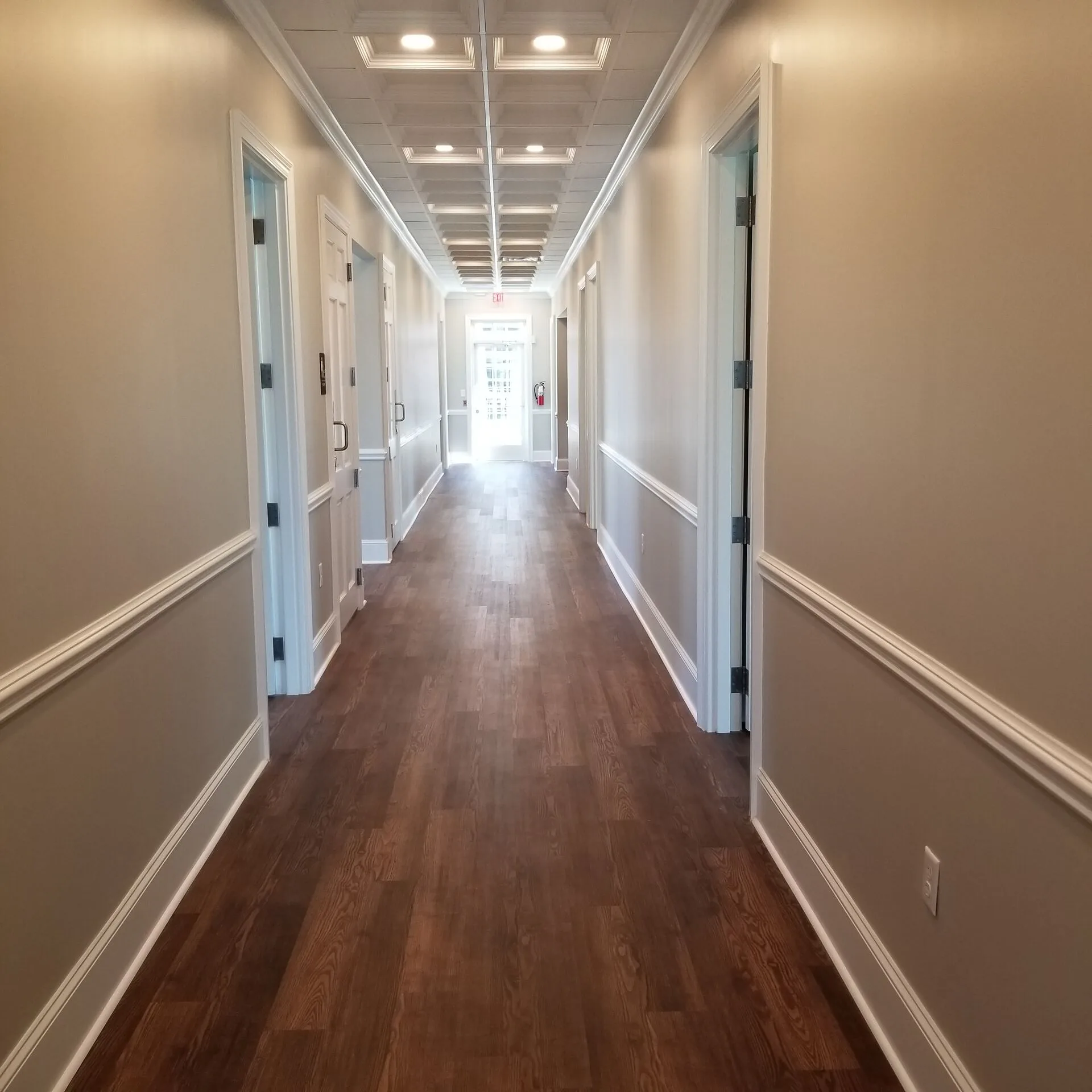 Classical professional office interior with coffered ceiling and paneled wainscoting by Harber Built