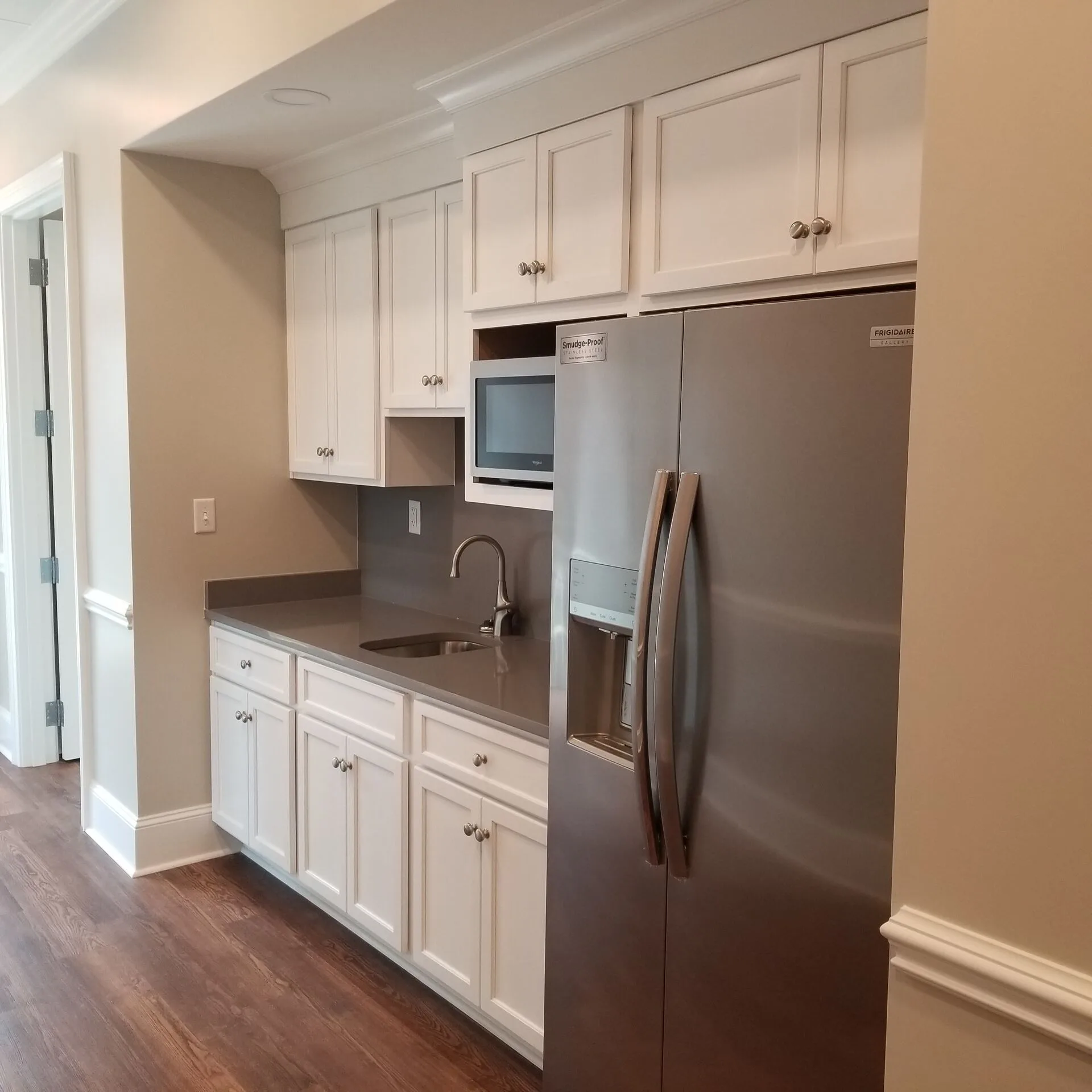 ADA-compliant restroom with grab bars and marble tile