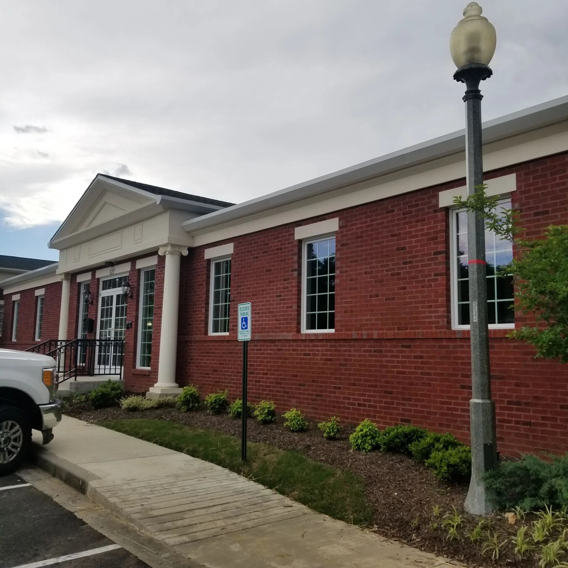 Exterior elevation — red brick with accessible parking