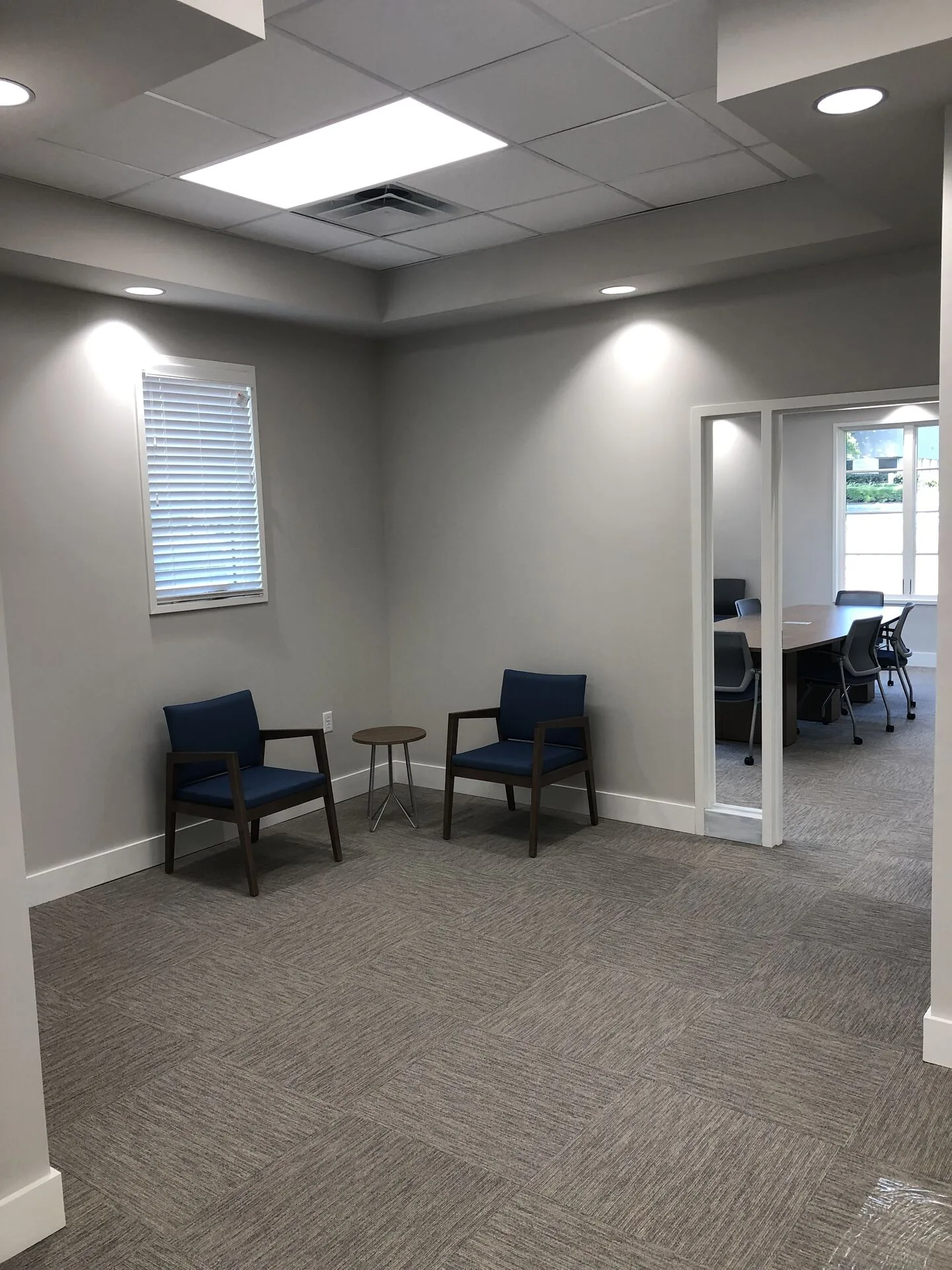 Reception waiting area with conference room glimpse