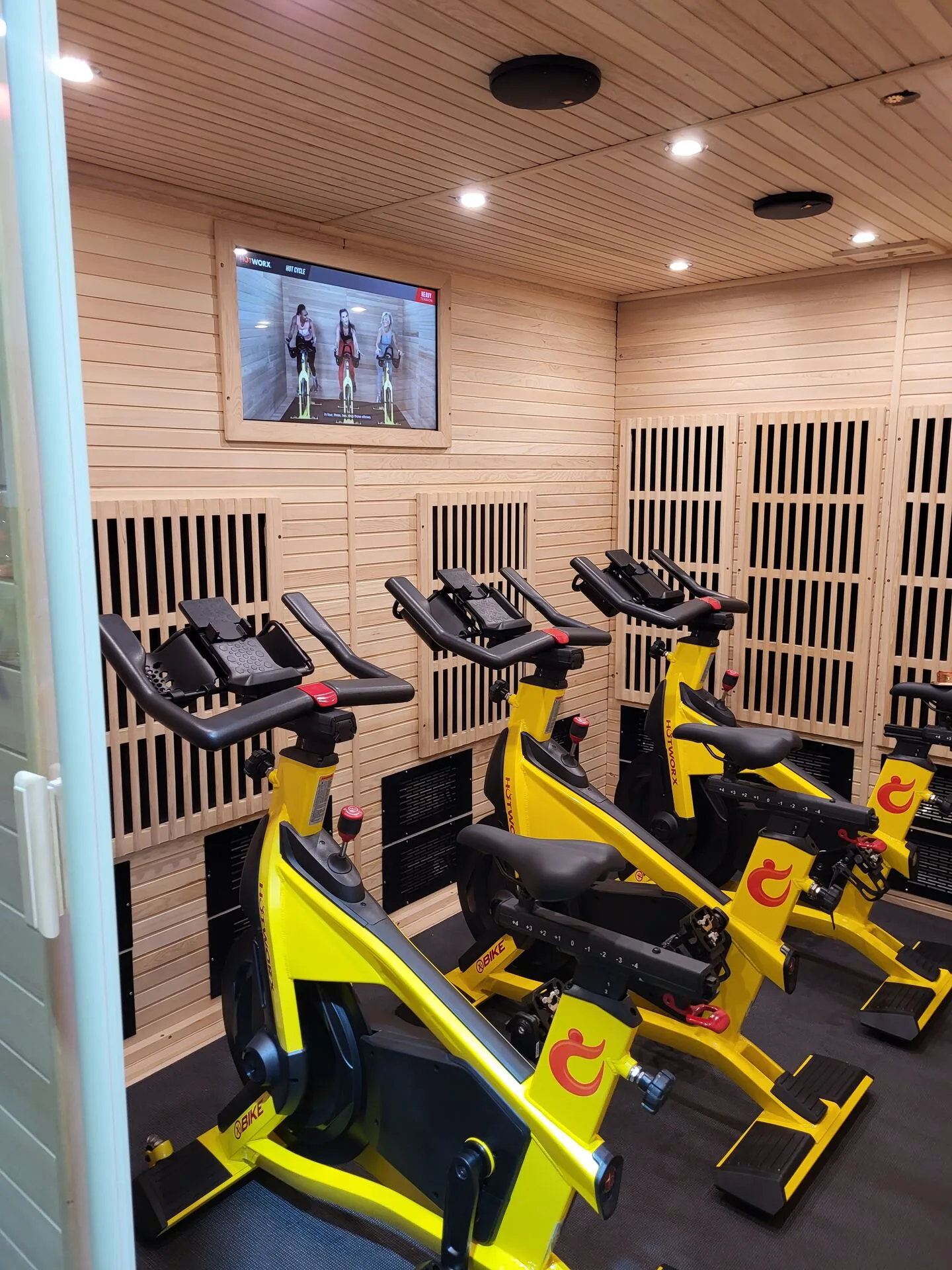 Hotworx interior — bar seating with branded backdrop