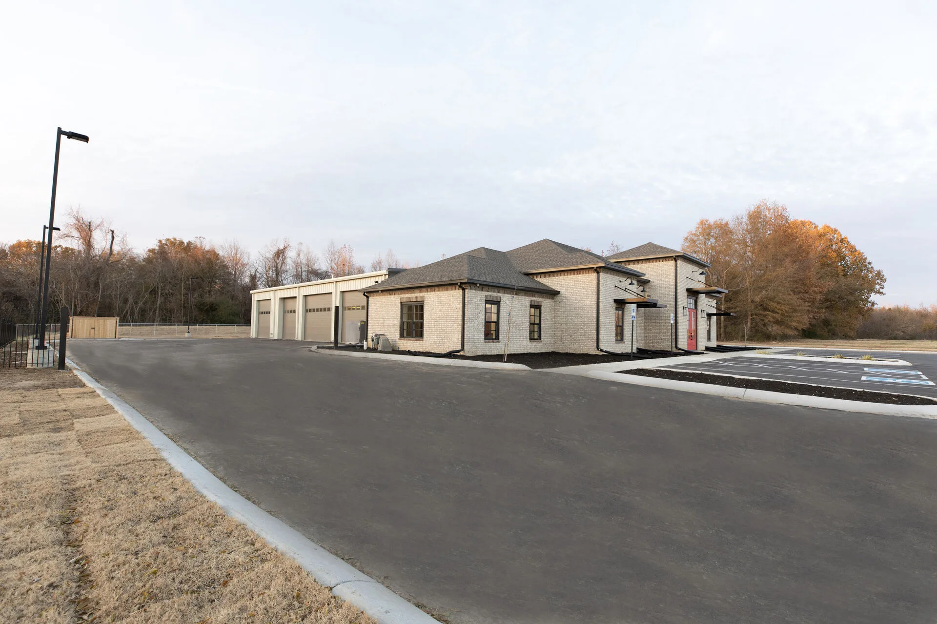 Site panorama — office front with attached warehouse and parking