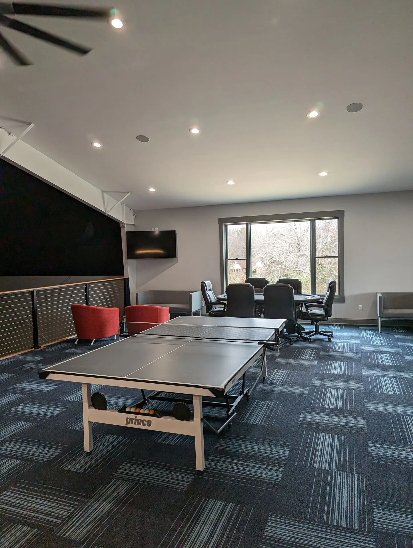Game room dining and ping-pong area with picture window