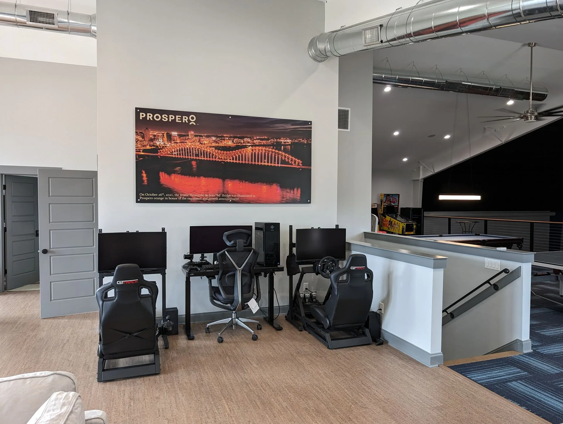 Game room loft with racing simulator stations and large wall art