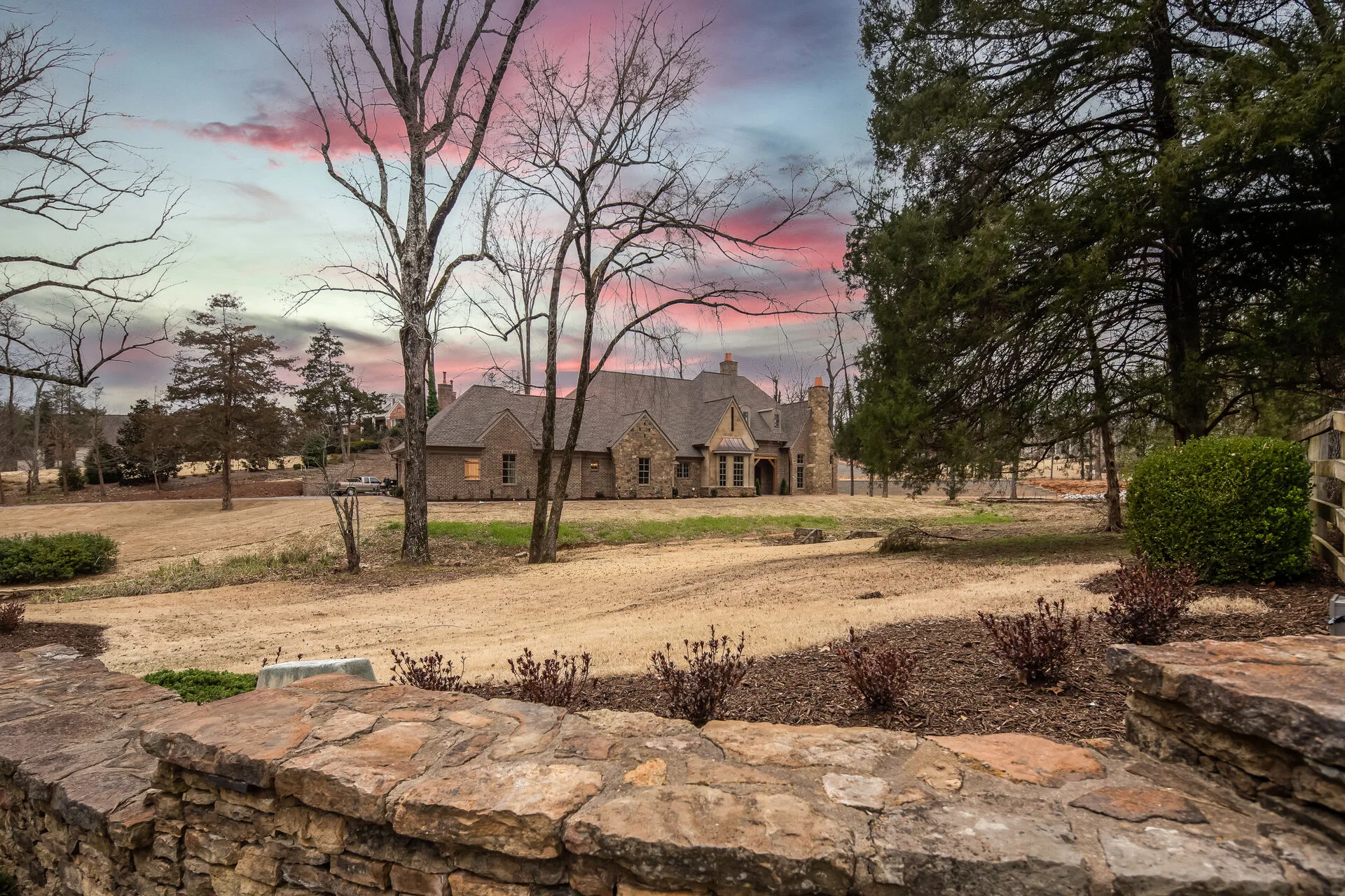 Custom stone residence at twilight — PCS Builder West Tennessee
