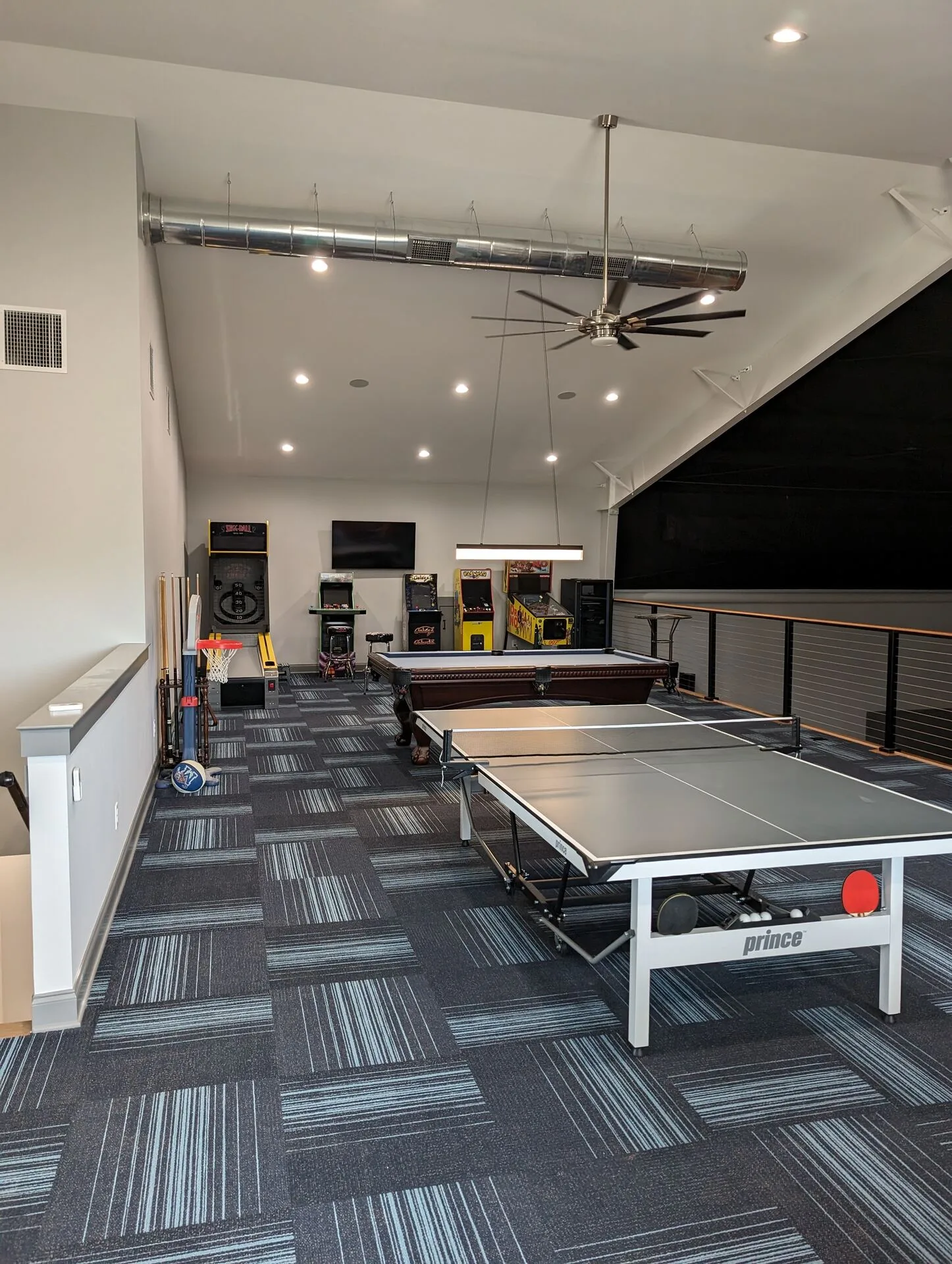 Game room with pool table, ping pong, and arcade cabinets